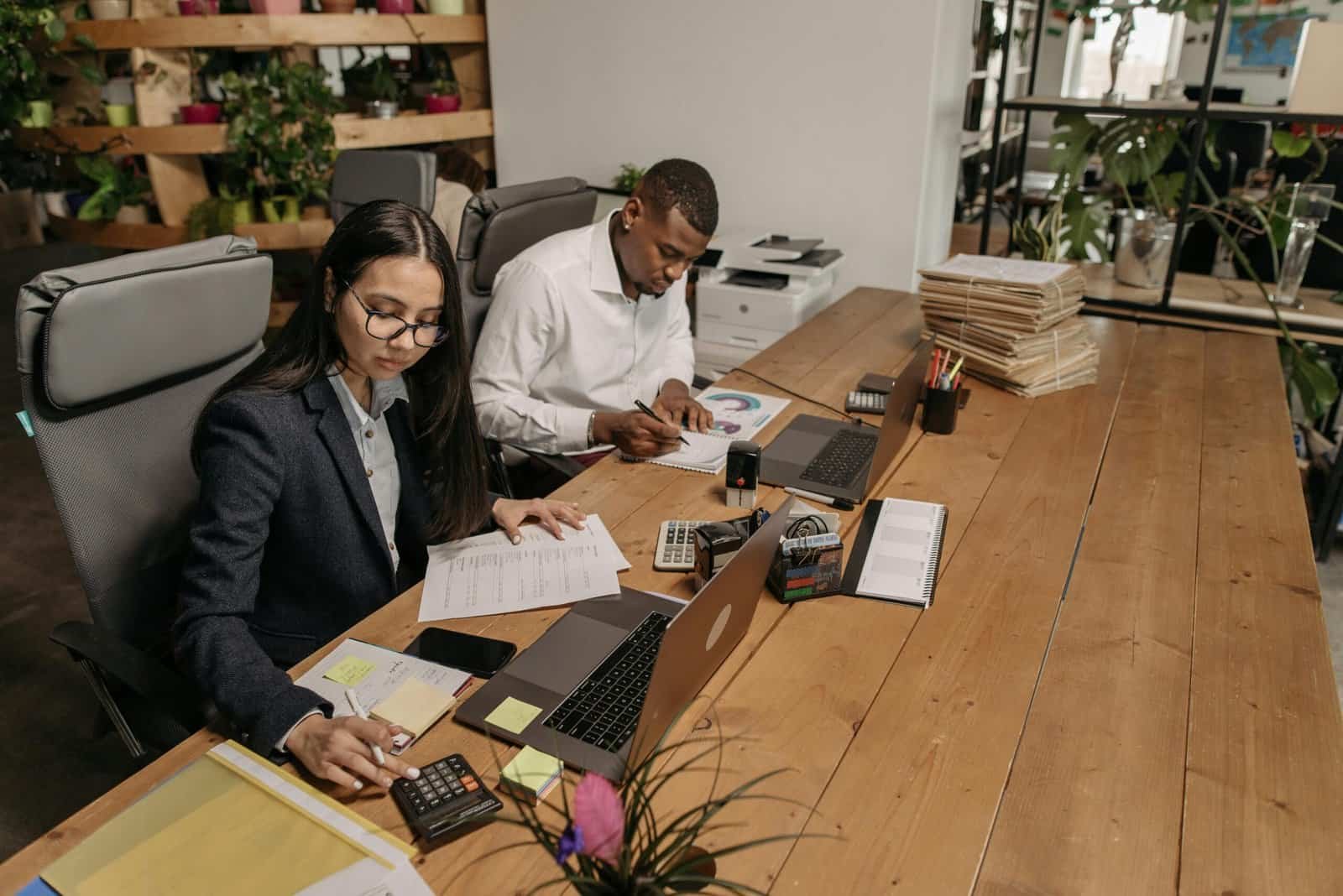 Business professionals collaborating on a project in a contemporary office environment.